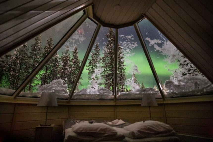 cabin hut window with northern lights view