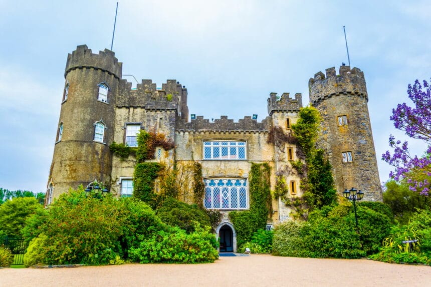 Malahide Castle surrounded by plants and small trees.