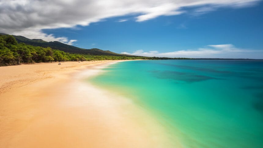 A white sand beach in Maui with turquoise waters.