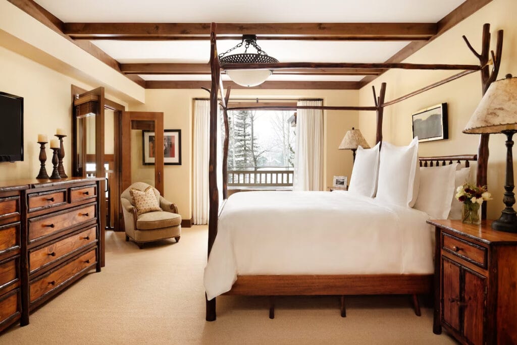 jackson Hole four season room with four poster bed and snowy view from the balcony