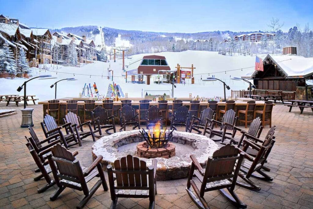 Ritz Carlton public area with fire pit and chairs in front of the ski lifts